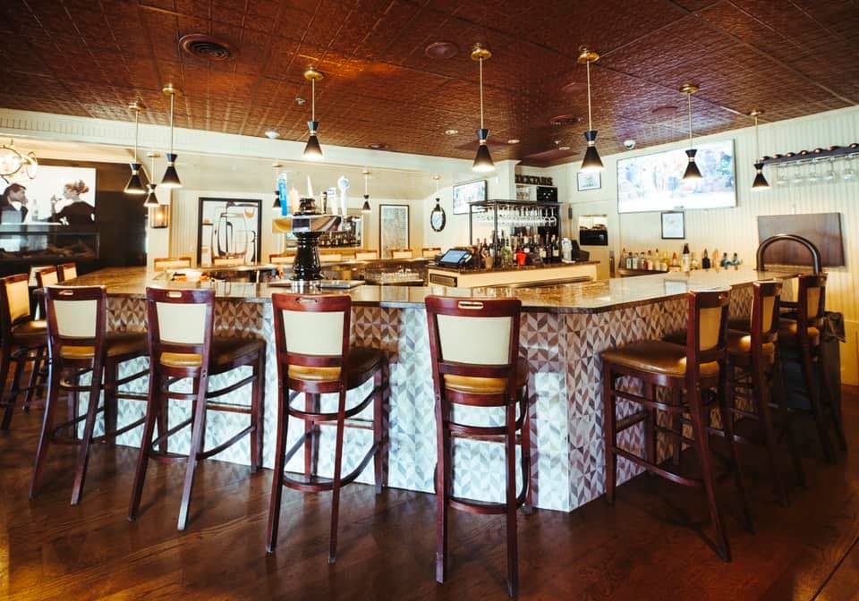 The granite bar at Paradiso Ristorante with pressed-tin ceiling and pendant lighting
