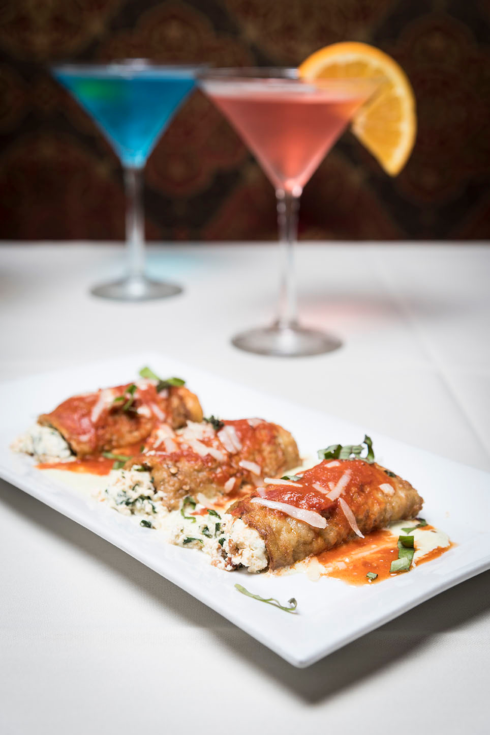 Stuffed eggplant rolls with tomato sauce and shaved cheese