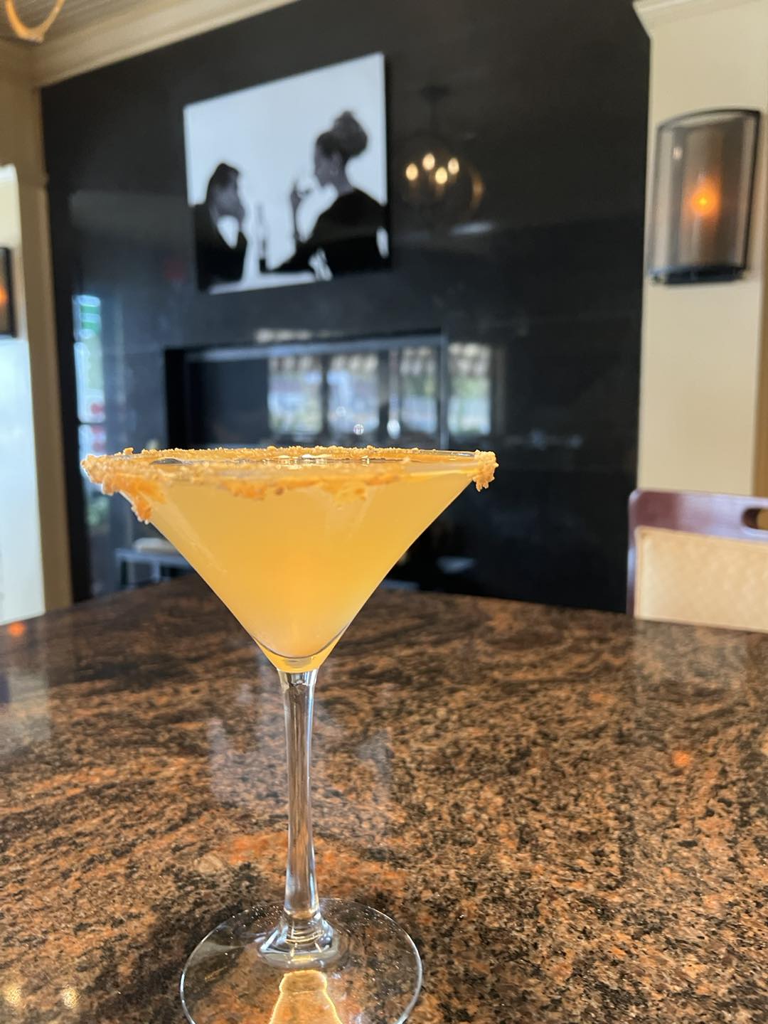 Golden dessert martini with a graham cracker rim at the bar